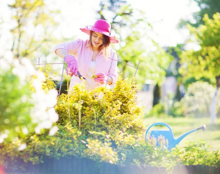 Gardener wearing protective equipment while working in changing weather